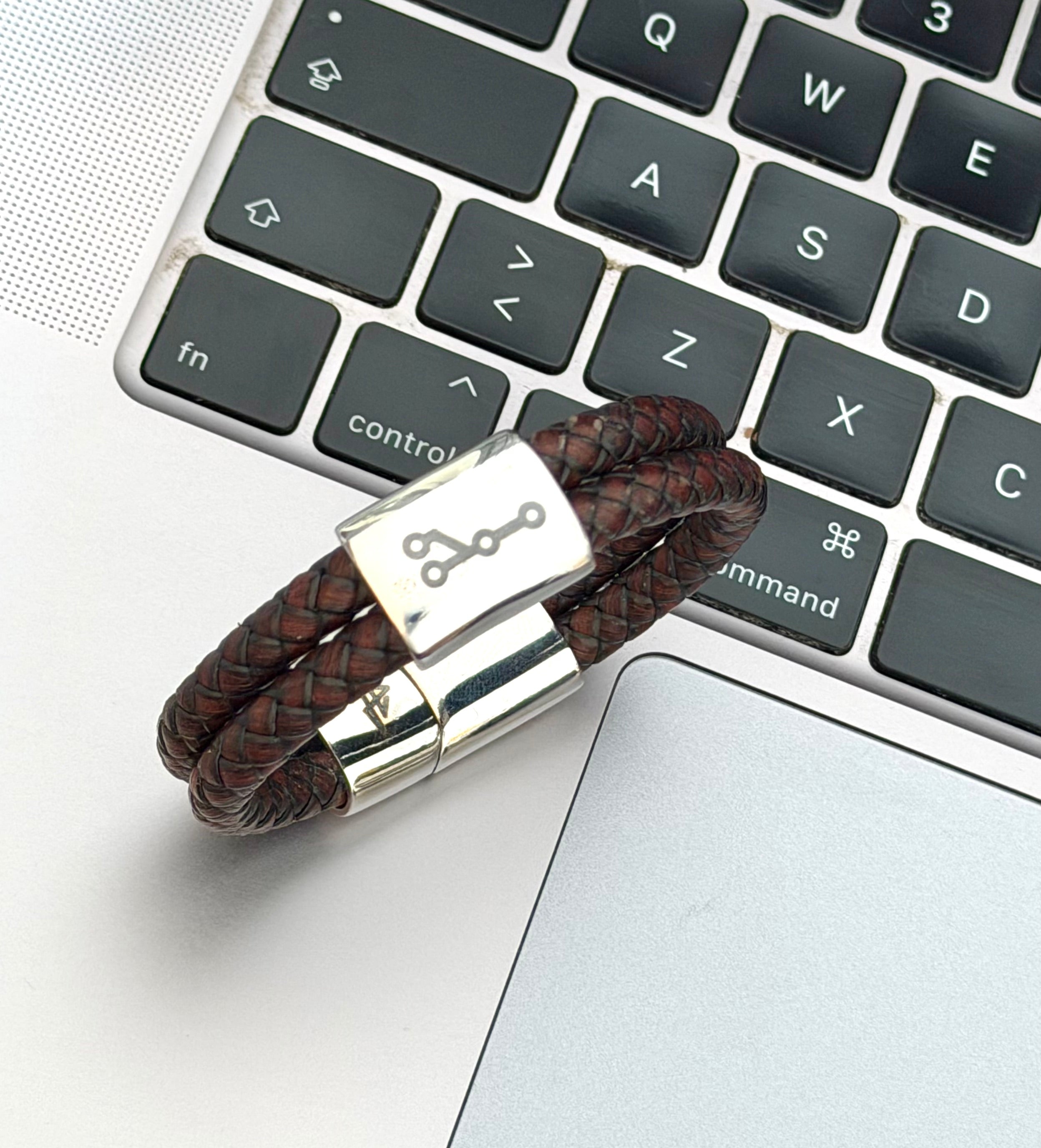 Branch armband i brunt läder vid tangentbord för utvecklare och programmerare
